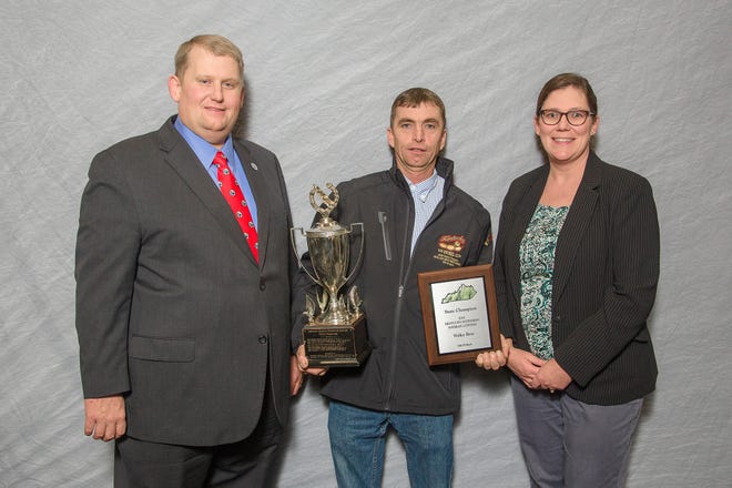 Kentucky Soybean Promotion Board Chair Ryan Bivens, at left, and UK's Carrie Knott present Waller Brothers' Jerrod Murphy of Union County with the State Champion Award in the Kentucky Soybeans Contest at the 2018 Crop Production Awards Banquet held in Bowling Green.