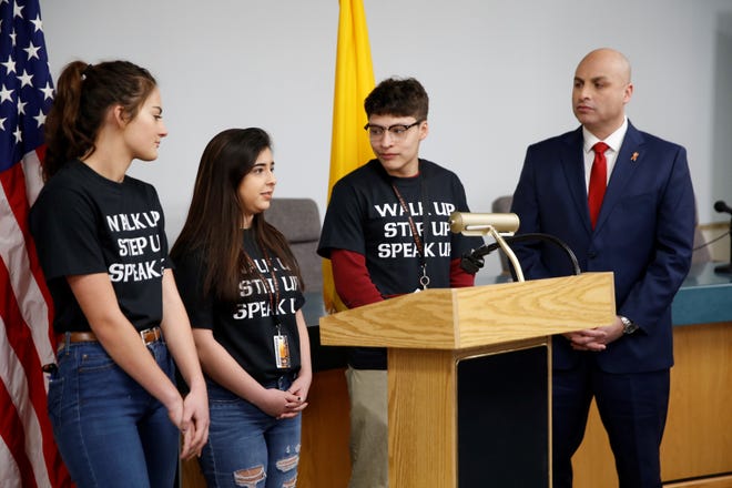 Aztec High School students Sarah Gifford, Maggie Dimas and Adam Jones talk about school safety as New Mexico Attorney General Hector Balderas listens Wednesday morning in the Aztec Municipal School District board room. The New Mexico Attorney General's Office announced the Rave Panic Button system will be installed at Aztec and Bloomfield high schools.