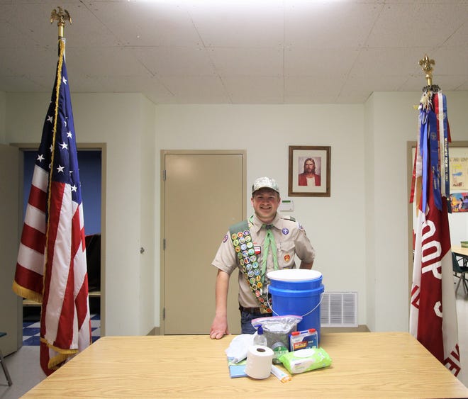 Wesley Shaver stands next to his project to become an Eagle Scout. The "Lock Down Buckets" were distributed to 140 class rooms in Ruidoso this month.