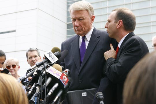 Attorney John Bouma (center) speaks to the press outside the Sandra Day O'Connor U.S. Courthouse on July 22, 2010.