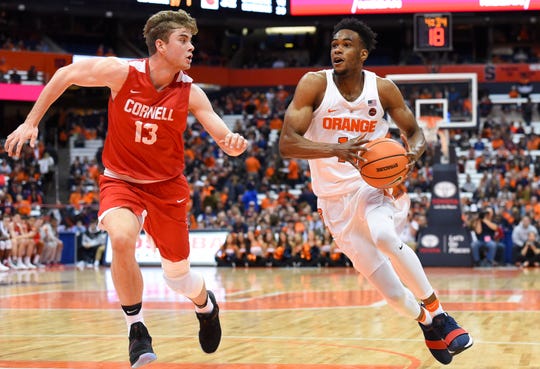 Syracuse Orange forward Oshae Brissett (11) drives to the basket against the defense of Cornell Big Red forward Stone Gettings (13) during the second half at the Carrier Dome Nov. 10, 2017.  Rich Barnes-USA TODAY Sports
