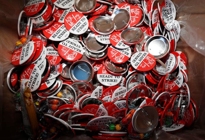 In this Jan. 17, 2019, file photograph, buttons for a teachers' strike sit in a box in the union's headquarters in south Denver.
