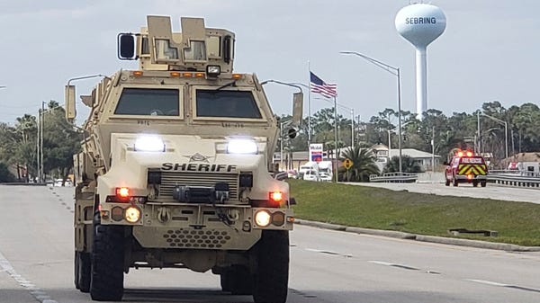 A sheriff's department armored vehicle arrives at...