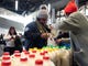 TSA worker Amelia Williams is given a bottle of milk at a food bank for government workers affected by the shutdown, Tuesday, Jan. 22, 2019, in the Brooklyn borough of New York. (AP Photo/Mark Lennihan) ORG XMIT: NYML106