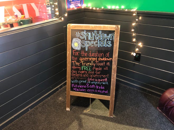 A sign seen outside The Friendly Toast, offering specials for those affected by the partial government shutdown.