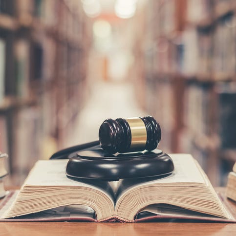 Judge gavel on open law textbook