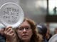 A woman displays her thoughts, written out on a disposable plate, during the 'Occupy Hart' protest against the partial government shutdown sponsored by American Federation of Government Employees at the Hart Senate Office Building at the US Capitol in Washington, DC on 23 Jan. 23, 2019. Federal workers and their supporters stood silently for 33 minutes for the 33 days of the shutdown. 