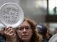 A woman displays her thoughts, written out on a disposable plate, during the 'Occupy Hart' protest against the partial government shutdown sponsored by American Federation of Government Employees at the Hart Senate Office Building at the US Capitol in Washington, DC on 23 Jan. 23, 2019. Federal workers and their supporters stood silently for 33 minutes for the 33 days of the shutdown. 
