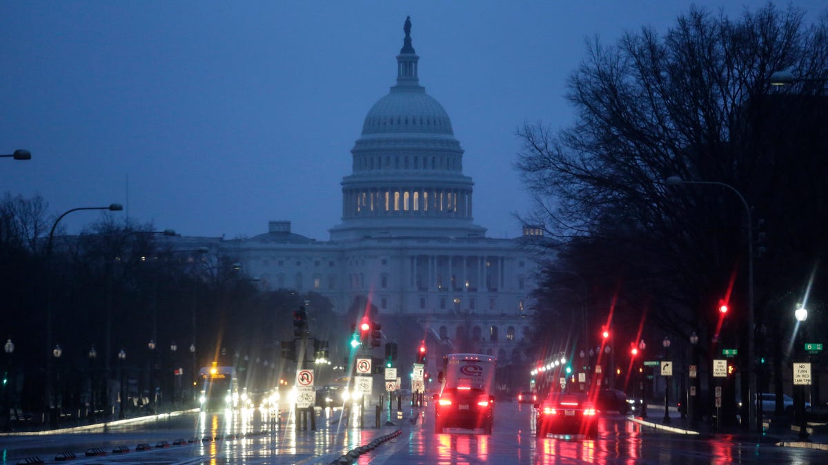 The Capitol is seen early Thursday, Jan. 24, 2019, as rain falls on Pennsylvania Avenue in Washington, with the partial government shutdown in its second month. The Senate will vote on two competing proposals today to end the impasse, but neither seems to have enough votes to advance.