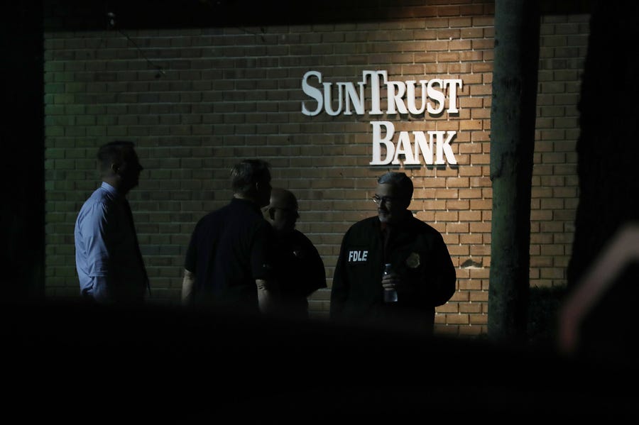 Law enforcement officials investigate the scene where five people were killed at a SunTrust Bank branch on January 23, 2019 in Sebring, Florida.