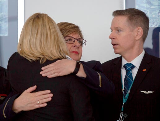 Airline employees hug before a press conference on aviation safety during the shutdown at Ronald Reagan Washington National Airport in Arlington, Va. on Jan.24, 2019.