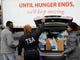 TSA employee Princess Young, center, loads food into a car after visiting a food pantry for furloughed government workers affected by the federal shutdown, Wednesday, Jan. 23, 2019, in Baltimore.