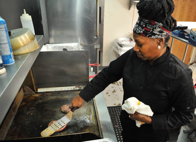Tamitha Bailey, Owner of Southern Girls Cafe & Catering, located inside the Wichita Falls Reginal Airport,  prepares burgers Friday afternoon after the restaurant announced it would give free burgers to furloughed government employees.