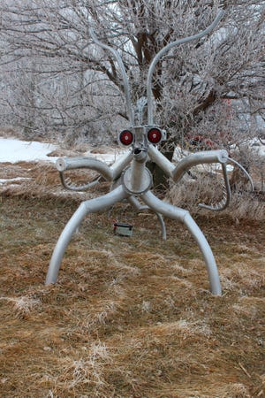 In this Jan. 13, 2019 a praying mantis sculpture is displayed near Martin Freed's home in Loomis, Neb. Spiders, the praying mantis and other bugs are scattered along a half-mile stretch of road in Loomis. While the giant insects may appear to be characters in a science fiction movie upon first glance, they are the creation of Freed.