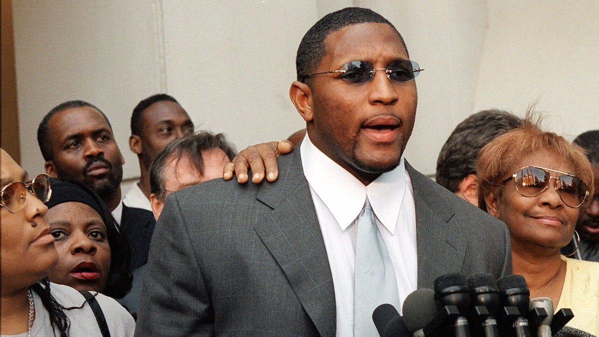 Ray Lewis, with his mother, Sunseria Keith, left, and grandmother Elease McKinney, right, address the news media outside the Fulton County Superior Court in Atlanta on June 6, 2000.