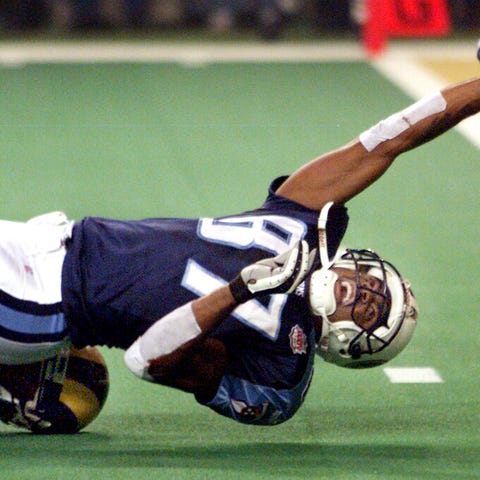 Titans WR Kevin Dyson tries to stretch across the...