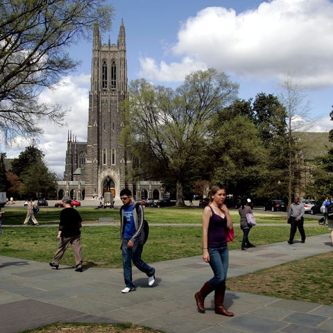 People walk on the campus of Duke University in...