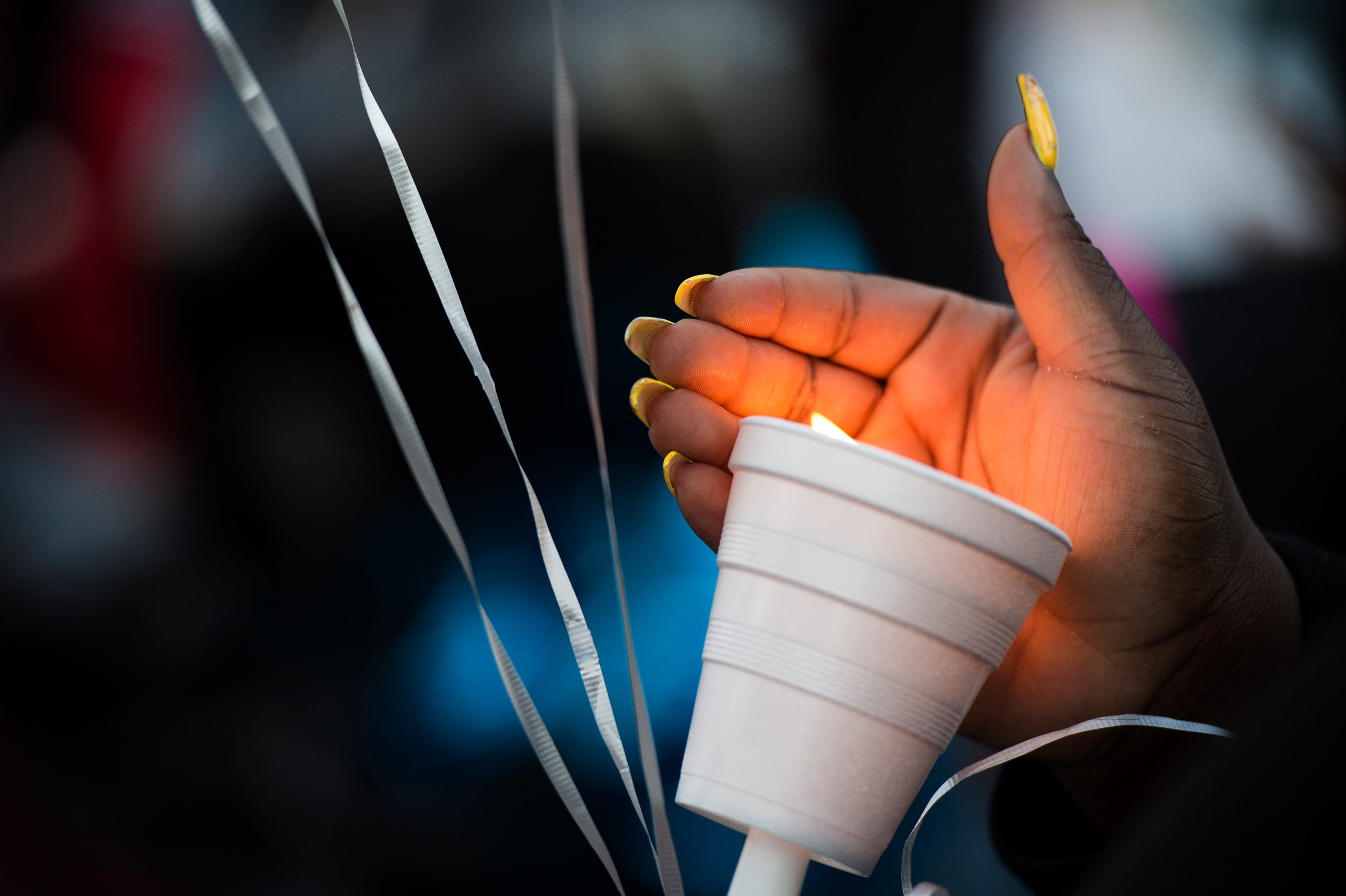 Tiffany Copeland, wife of Jermaine Massey, holds a lit candle during a vigil for her husband on Wednesday, March 21, 2018.