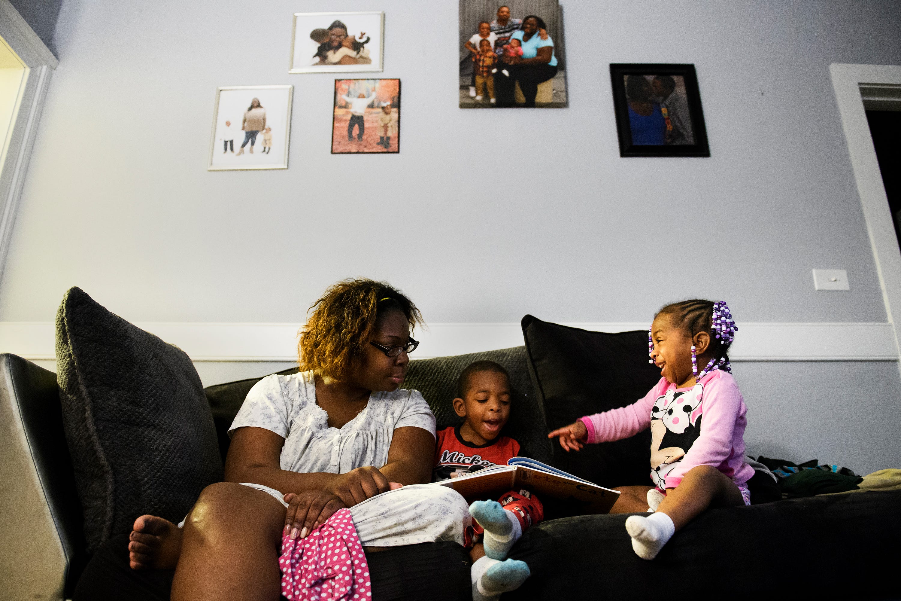 Tiffany Copeland reads a book with her son, Jermier, 6, and daughter Jenilya, 3, inside her home on Monday, Dec. 17, 2018.