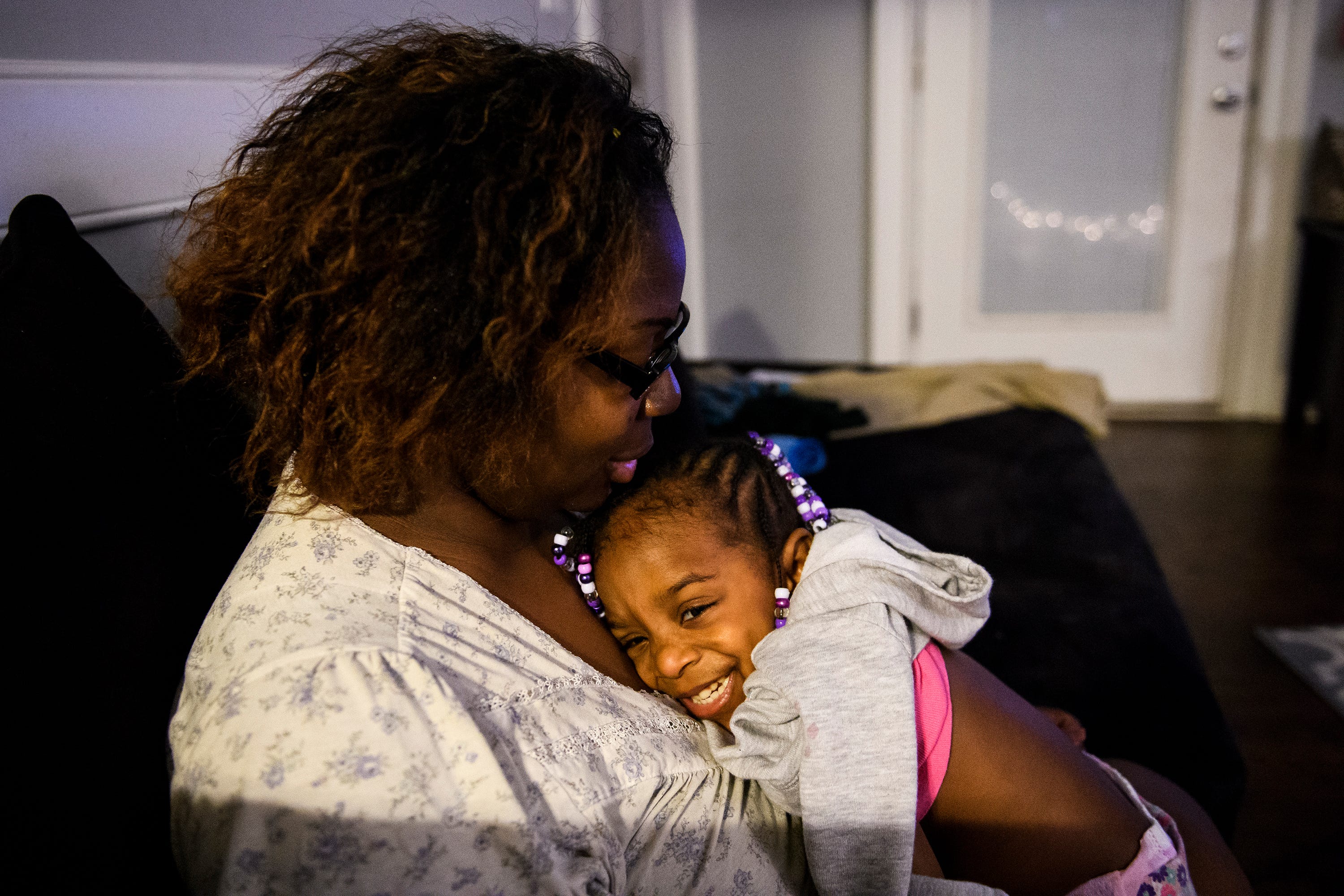 Tiffany Copeland embraces her daughter Jenilya, 3, inside her home on Monday, Dec. 17, 2018.