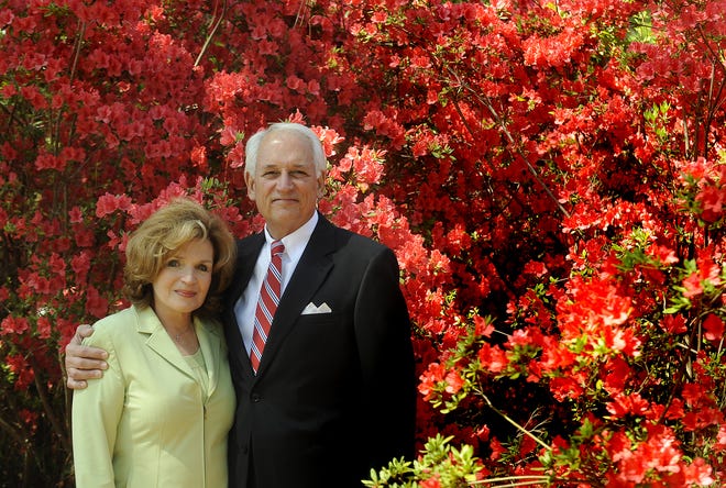 Troy University chancellor Jack Hawkins and his wife Janice Hawkins pose with blooming azaleas at their home in Troy.