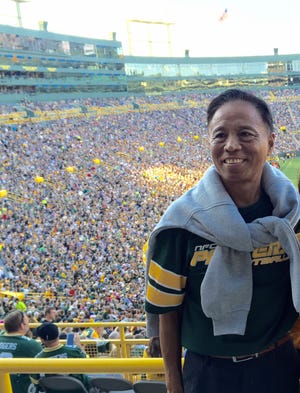 After Li Hu noticed how Oshkosh became a ghost town during Sundays in the football season, he started to learn more and became a Packers fan.