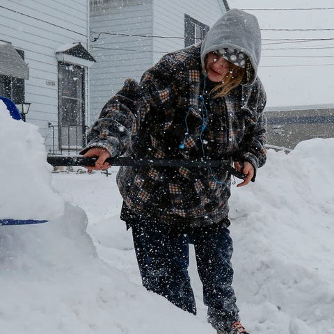 Crystal Oestreich, of Manitowoc, Wisc., shovels...
