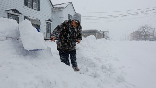 Crystal Oestreich, of Manitowoc, Wisc., shovels...