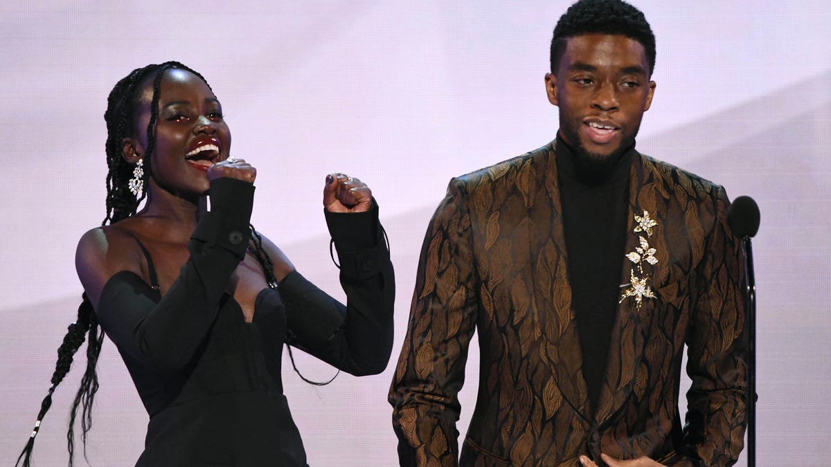 Lupita Nyongío and Chadwick Boseman take the stage as the cast of "Black Panther" accepts the award for outstanding performance by a cast in a motion picture.