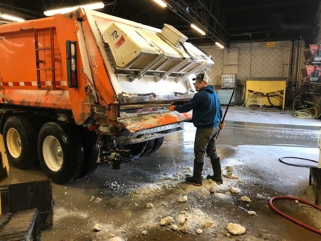 Fond du Lac County Highway Department worker Tyler Thielke clears chunks of frozen salt from a plow. The frozen salt clogs up the augers and doesn't work when temperatures get this cold, said Fond du Lac Colunty Highway Commissioner Tom Janke. He is warning area residents the roads are slippery and ice-covered.
