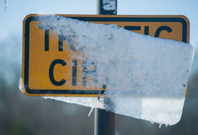Melting snow on traffic signs in Madison, Miss., along with freezing temperatures, are all that remain Tuesday, Jan. 29, 2019, after cold front moved through state leaving the Jackson metro area with less than an inch of snow.  