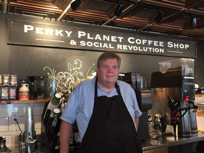 Owner Richard Vaughn stands in his new coffee shop, Perky Planet, on St. Paul Street in Burlington in late January 2019.