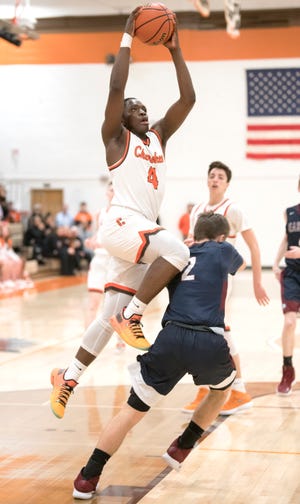 Cherokee's Olare Oladipo puts up a shot over Eastern's Andrew Heck during the 1st quarter of the boys basketball game played at Cherokee High School on Tuesday, January 29, 2019.  Cherokee defeated Eastern, 56-52.