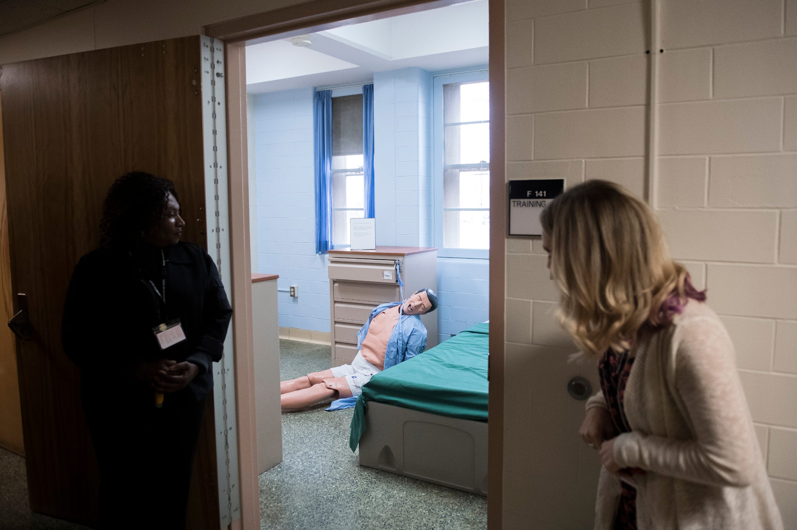 Chief nursing officer Evelyn Ngwa, left, and instructor of nursing Erica Misiak look in on a simulation dummy at Ancora Psychiatric Hospital in Winslow Twp., N.J.