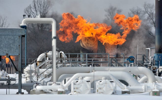Fire comes out of the top of two silo-like structures at Consumers Energy's Ray Compressor Station in Armada Twp. Wednesday.