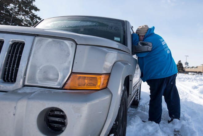 Tricia Almanza, street outreach coordinator for The Harbor, looks through the window of a car Wednesday, Jan. 30, 2019. Almanza is looking for any signs that someone may be living in the vehicle. The search was conducted as part of a nationwide effort to survey local populations.