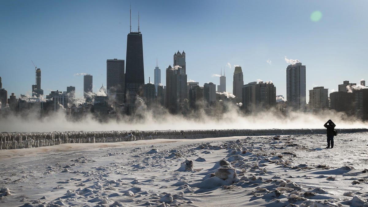 CHICAGO, ILLINOIS - JANUARY 30: A visitor takes a picture of the Chicago skyline along the city's lakefront as temperature hung around -20 degrees on January 30, 2019 in Chicago, Illinois. Businesses and schools have closed, Amtrak has suspended service into the city, more than a thousand flights have been cancelled and mail delivery has been suspended as the city copes with record-setting low temperatures.  (Photo by Scott Olson/Getty Images) ORG XMIT: 775289932   ORIG FILE ID: 1126248745