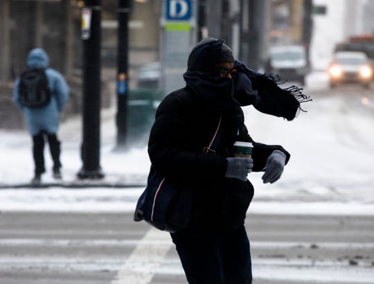 A Pedestrian walks through a winter storm  in Downtown Cincinnati. Jan. 30, 2019. 