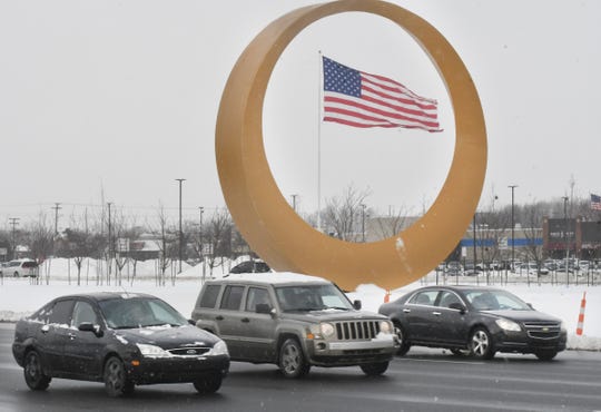 The Golden Corridor sculpture sits in the median of the divided highway of M-59, Hall Road, in Sterling Heights.