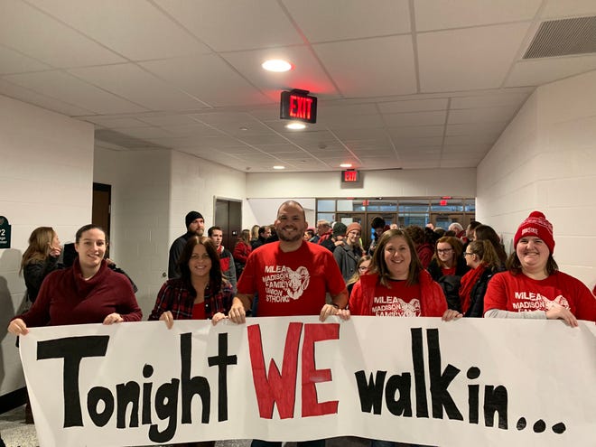 Members of the Madison Local Education Association (MLEA), a union that represents many Madison teachers, hold a banner prior to a Madison School Board meeting Wednesday, January 30, 2019.