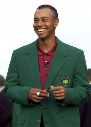 Tiger Woods smiles after receiving his Masters green jacket after winning the 2001 Masters golf tournament at the Augusta National Golf Club. (AP Photo/Amy Sancetta)