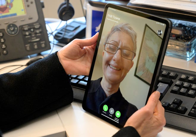 A woman uses her Ipad for a Facetime conversation, on January 29, 2019 in Rome.