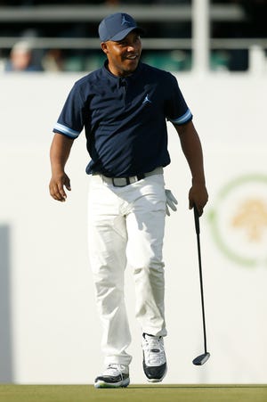 Harold Varner III reacts after making his putt attempt on the 16th green.