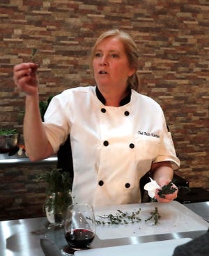 Pam Dennis shows students how to remove fresh thyme leaves from the stems in 2019. Four years later, Dennis is taking Chef's Pam Kitchen further in seeking franchise partners nationally for the cooking class model she and her husband created.
(Photo: Rick Wood, Milwaukee Journal Sentinel)