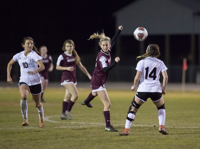 Hailey Bastian (23) follows the ball after heading it during the District 1-4A girls soccer tournament final between Niceville and Navarre at Navarre High School on Thursday, January 31, 2019.  Niceville won 7-6 in penalty kicks.