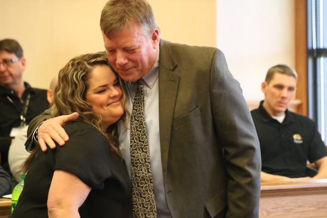 Judge Bruce Winters hugs and congratulates Kylie Zunk, who graduated from the Ottawa County Drug Court program.