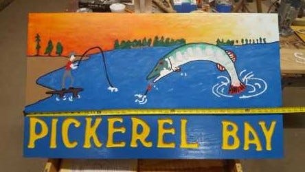 In late September 2018, someone went to Big Eau Pleine County Park, in the town of Green Valley, and cut and stole this routed and hand-painted “Pickerel Bay” wooden sign from its two wooden support posts.