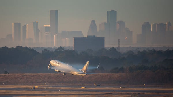 The skyline of downtown Houston rises behind a...