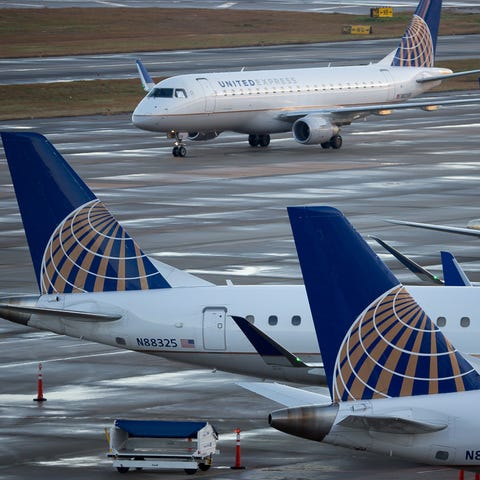 United Airlines planes fill the gates of Terminal...