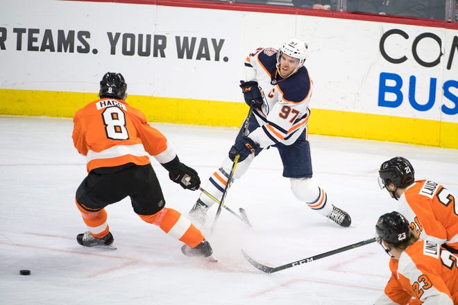 Oilers' Connor McDavid (97) fires the puck past Flyers' Robert Hagg (8) Saturday, Feb. 2, 2019 at the Wells Fargo Center in Philadelphia, Pa. Flyers won 5-4 in overtime.